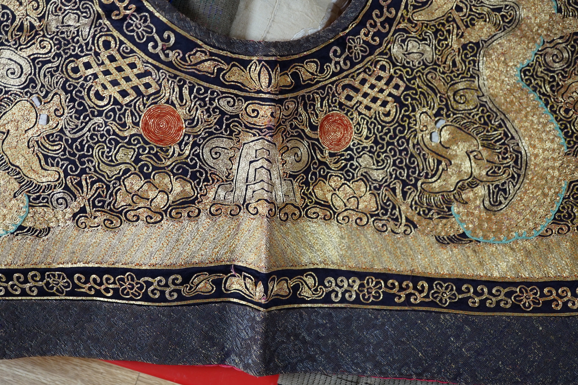 Two mid 20th century Chinese embroidered Rank Badges, a large gold thread dragon embroidered collar, three Chinese embroidered panels and a Japanese 1930’s Shantung silk dragon embroidered Kimono dressing gown